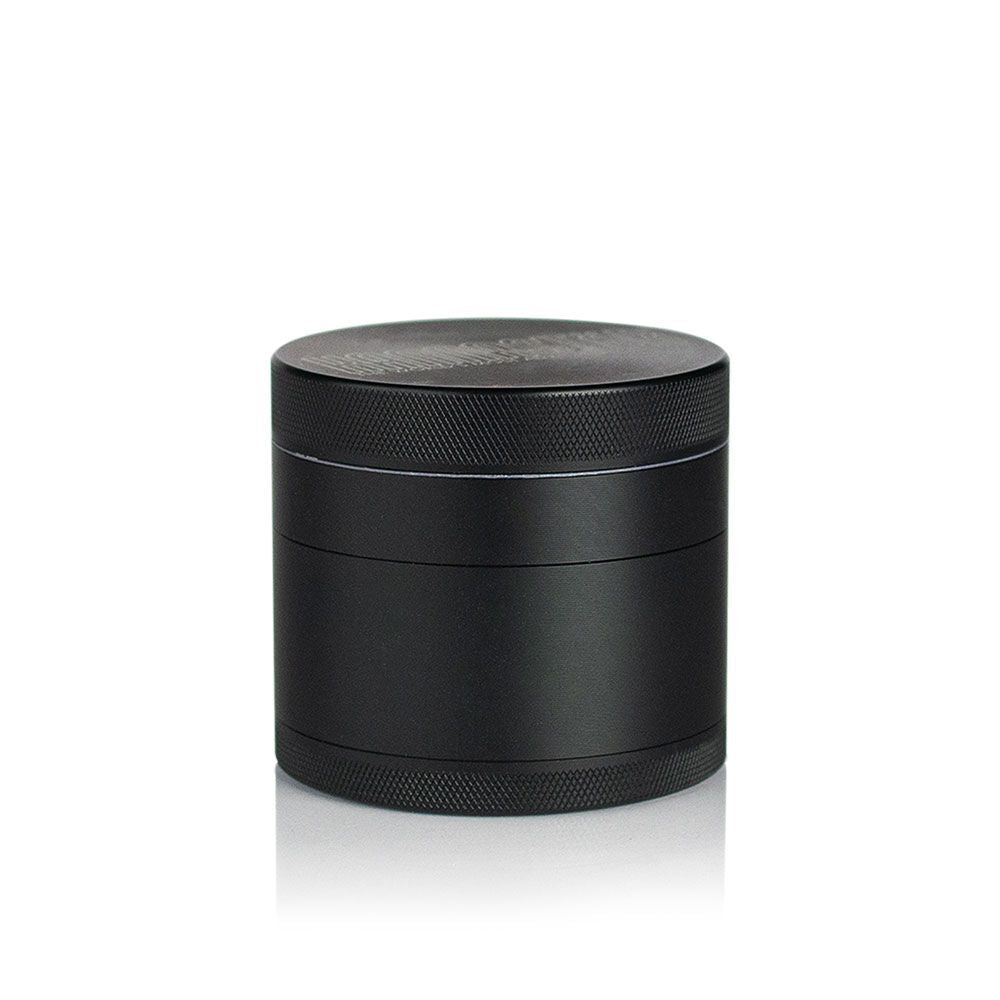 2.5 Multi Chamber Grinder - Black: A small, cylindrical, all-metal grinder with knurled bands for grip, featuring a four-piece modular design with a seam for separation.