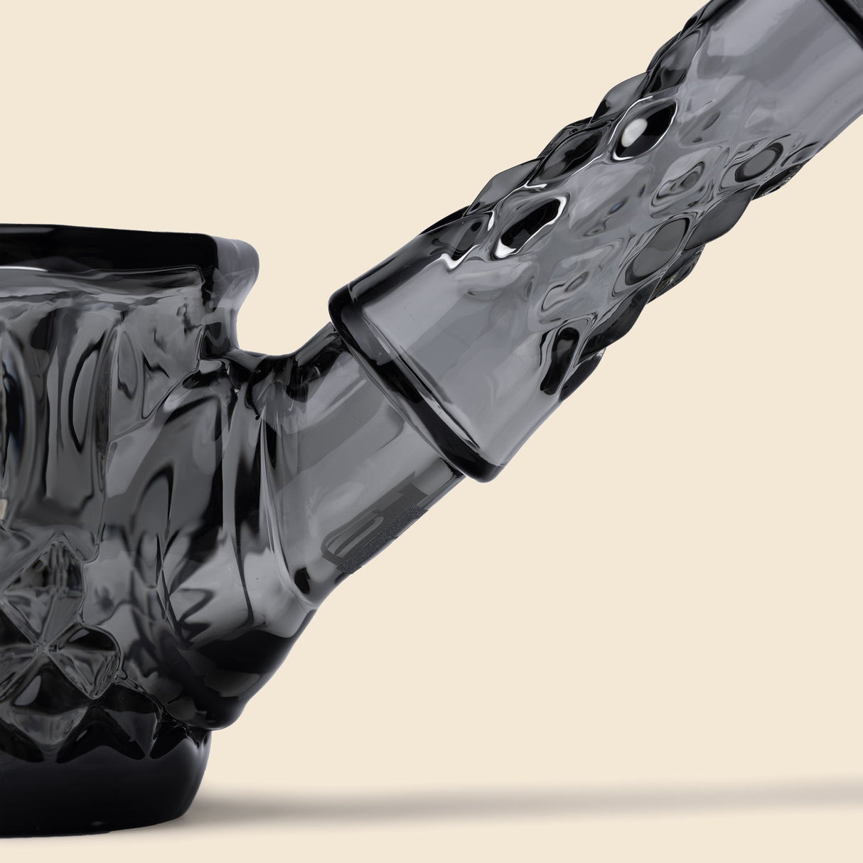 Highball Pipe close-up showing dark-smoke-tinted, textured glass with angled neck, joint, and slanted mouthpiece, highlighting its hand-blown, heirloom-inspired design.