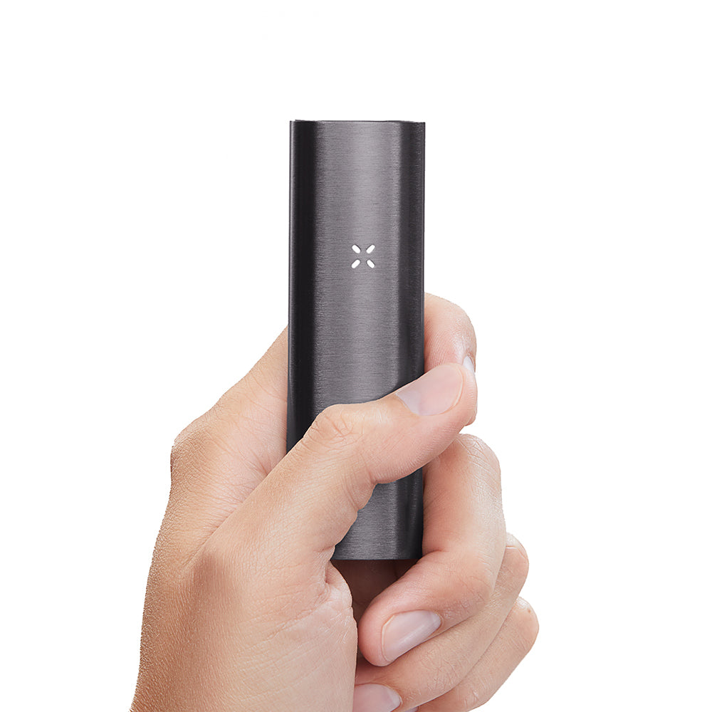 Hand holding the sleek PAX 2 Dry Herb Vaporizer with a visible flower LED indicator, showcasing its compact, ergonomic design and intuitive functionality.