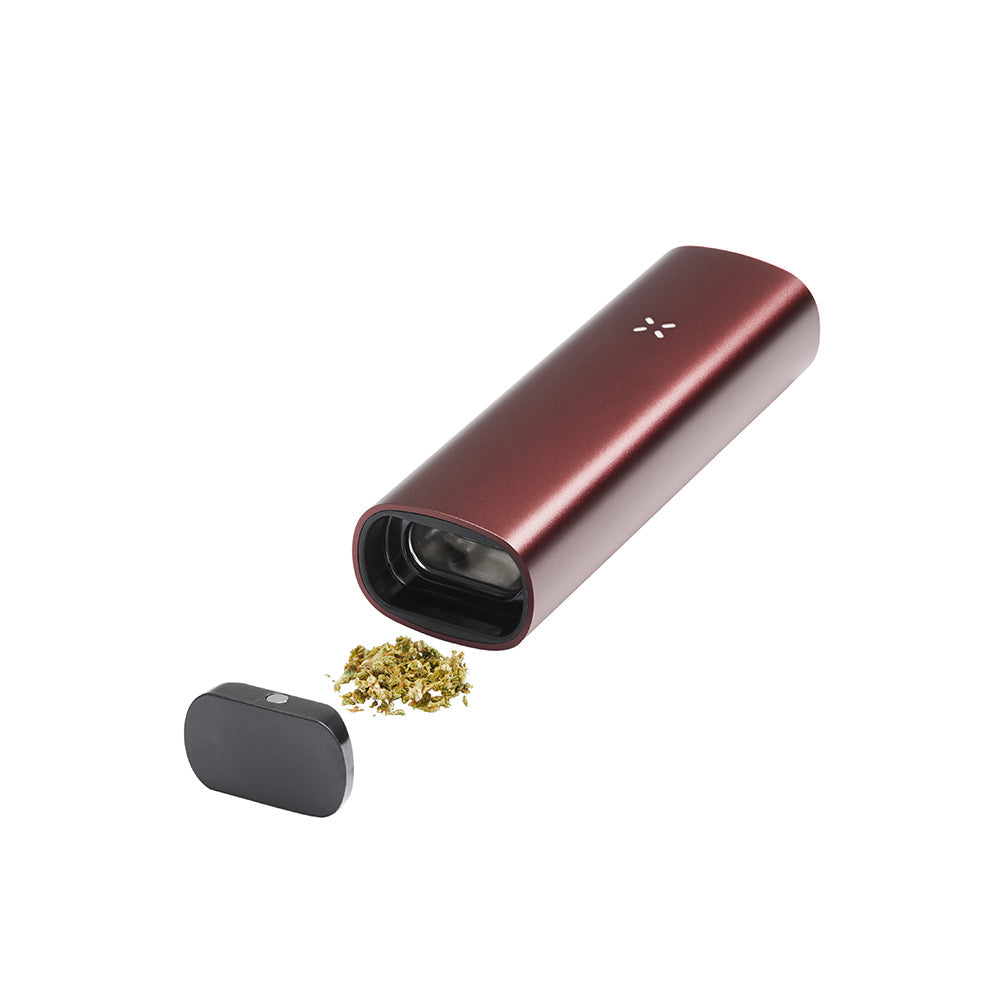 PAX 3 Basic Kit: Portable dry-herb vaporizer in a red anodized finish, shown with a removed mouthpiece and ground herb beside the chamber.