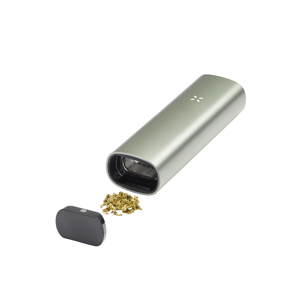 PAX 3 Basic Kit showing a pen-style dry-herb vaporizer with the magnetic mouthpiece removed, alongside a small pile of ground cannabis.