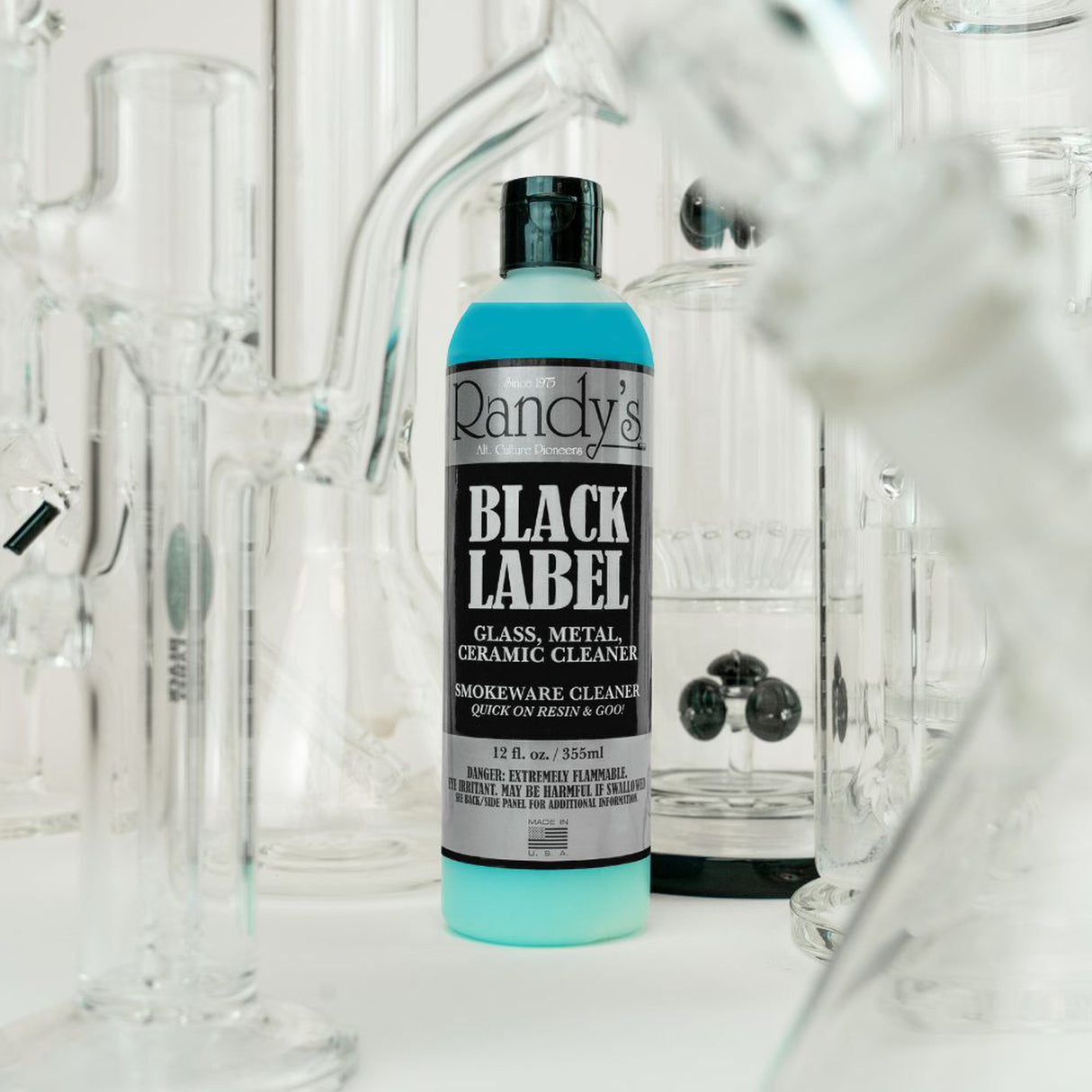 12oz Black Label Bong Cleaner bottles on display, highlighting packaging and effectiveness in cleaning smoking accessories, available in cartons of 16 units.