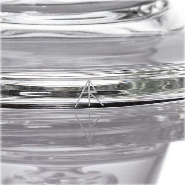 Close-up of Spire - Clear, a glass tumbler with thick walls, featuring an etched “AR” logo, showcasing MJ Arsenal's craftsmanship and sleek design.