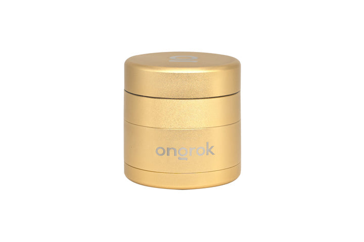 Mini EZ Grinder - 55mm, metallic-gold cylinder with ongrok branding, features stackable sections for grinding and storage, magnetic lid, and triangular aluminum teeth.