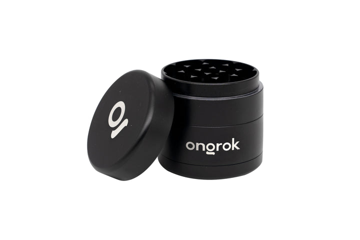Mini EZ Grinder - 55mm: Black metal grinder with removable lid, sharp teeth inside for grinding herbs. onorok branding visible on the side.