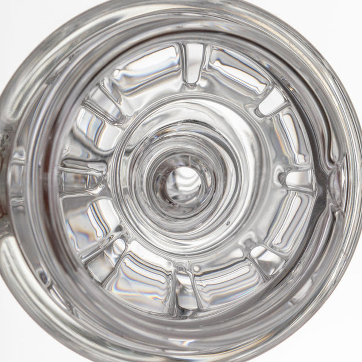 Top view of empty clear glass tumbler, reflecting light, showcasing the craftsmanship of the Halo Peak Attachment from the Alpine Collection by MJ Arsenal.