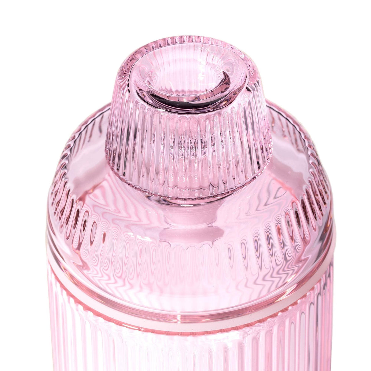Deco Gravity Bong, a translucent pink, vertically ribbed glass vessel with Art Deco design, featuring a snugly fitting lid and modern functionality.