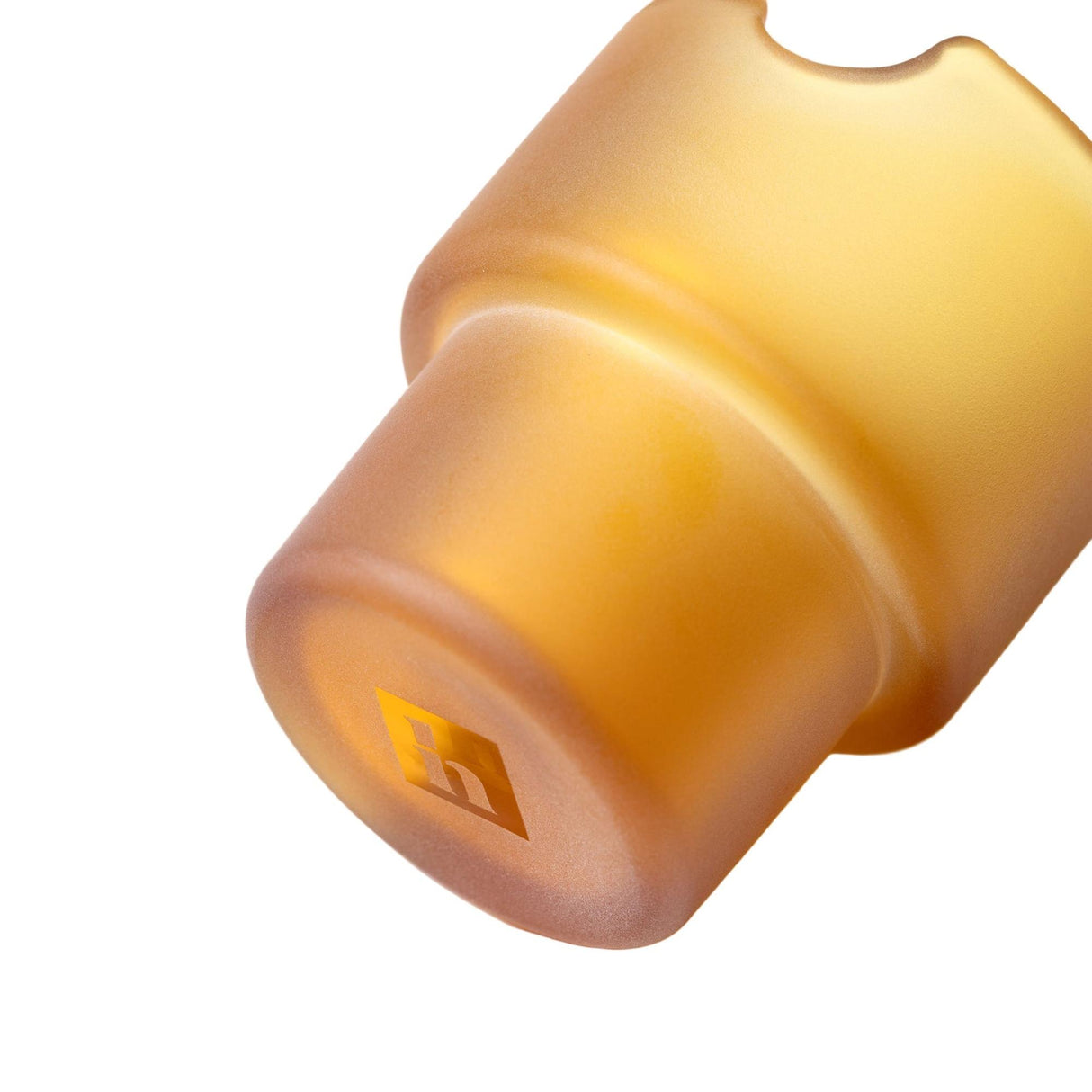 Close-up of a Flower Pots Ashtray Set lid, featuring a frosted-amber finish with an embossed “h” logo, exemplifying minimalist, handcrafted design.