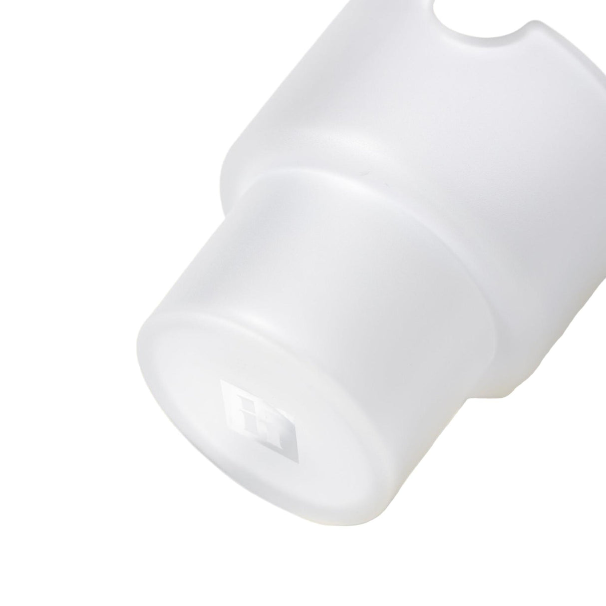 Close-up of a milky-white plastic cap, embossed with H, resembling a diffuser for the Flower Pots Ashtray Set, showcasing minimalist design and functionality.