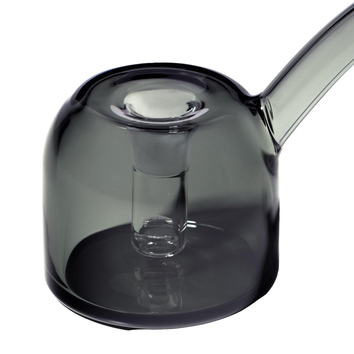 Close-up of the Vesper Bubbler, a smoke-grey glass vessel with an integrated infuser tube and curved handle/spout, showcasing its modern, elegant design.