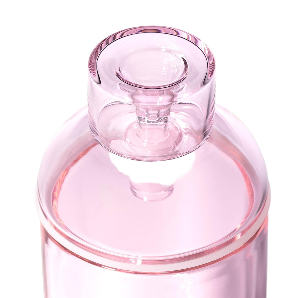 Close-up of the Vesper Gravity Bong, a translucent pink glass container with a matching lid, showcasing its sleek, elegant design and premium borosilicate glass construction.