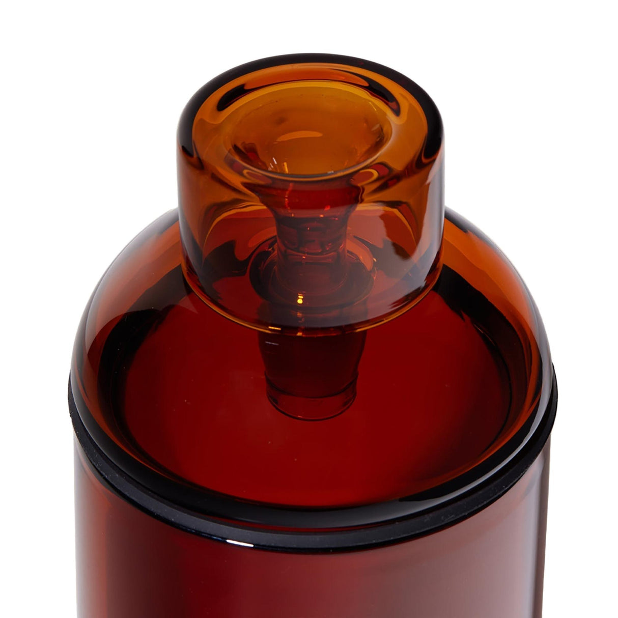The Vesper Gravity Bong, an amber-tinted cylindrical vessel with a snug-fitting stopper, showcases premium borosilicate glass design for smooth, gravity-powered smoking.