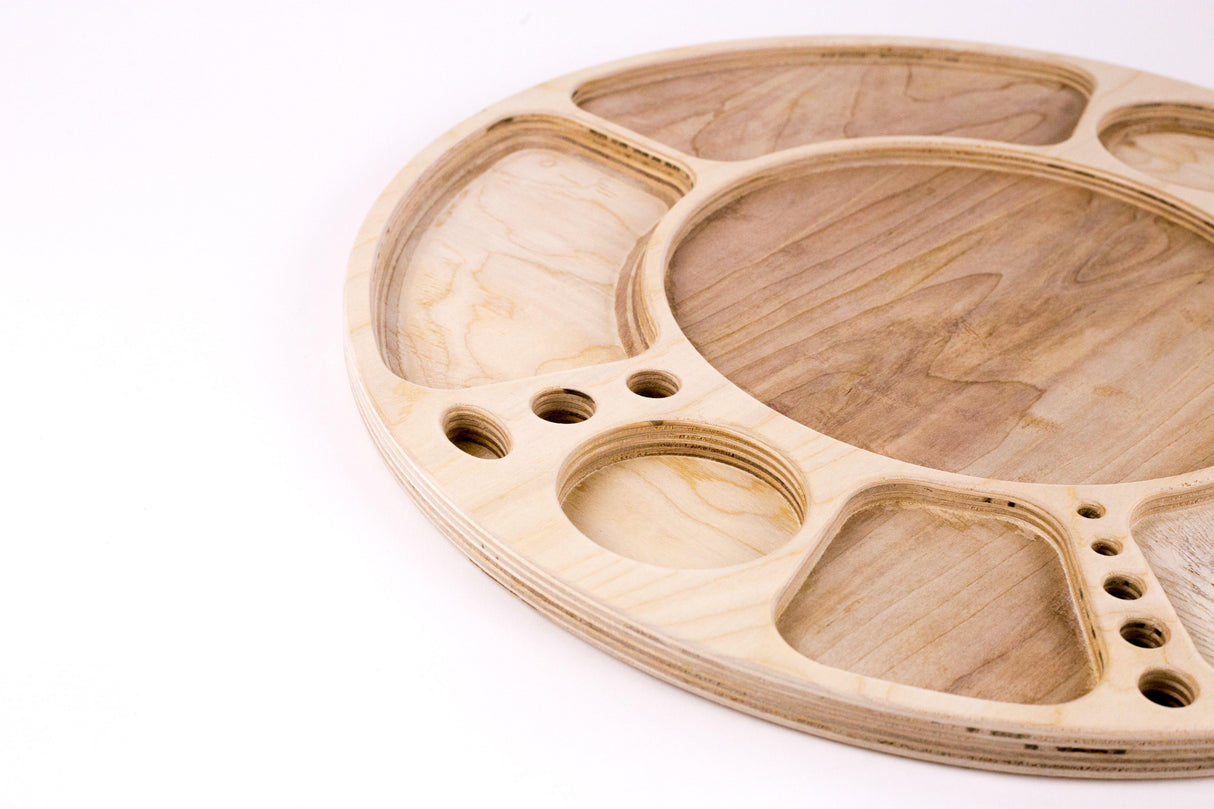 Spinning Rolling Tray: A round wooden palette with carved wells, central mixing area, and rotating base, showcasing fine-grained birch or walnut craftsmanship for organized display.
