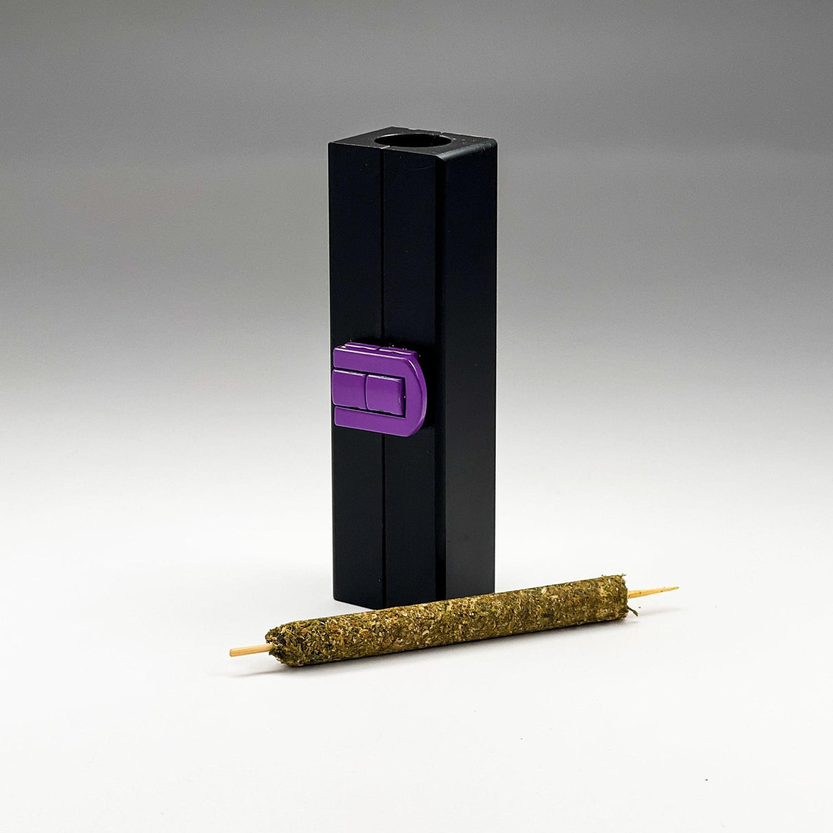 Mini CannaMold - Fits 1-2g: Black rectangular mold with purple switch, designed for creating slow-burning cannagars with integrated airflow for smooth draws. Complete kit included.