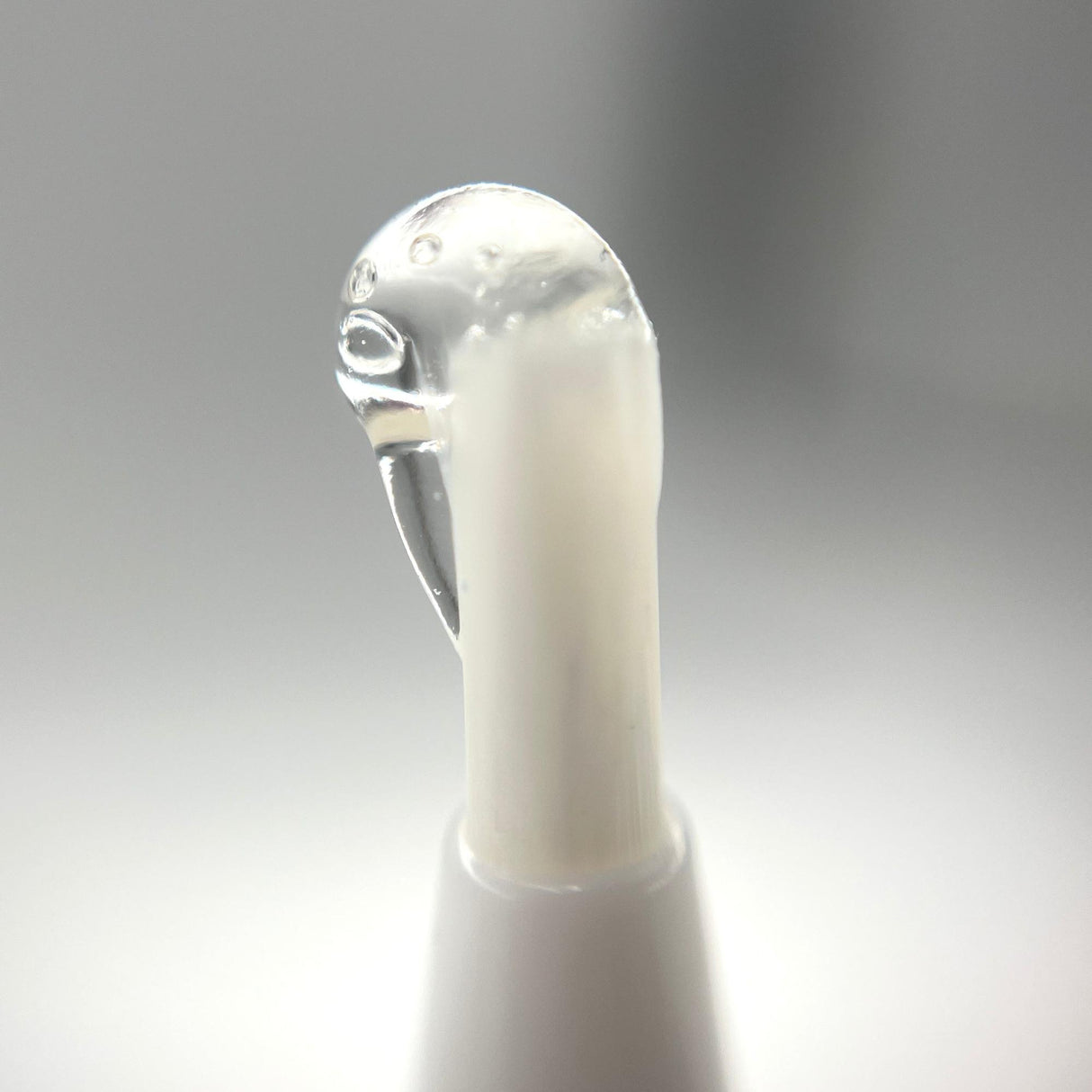 Rolling Glue Box - 4 ml - Carton of 24, featuring a close-up of the compact, white tube with built-in brush for precise, spit-free application.