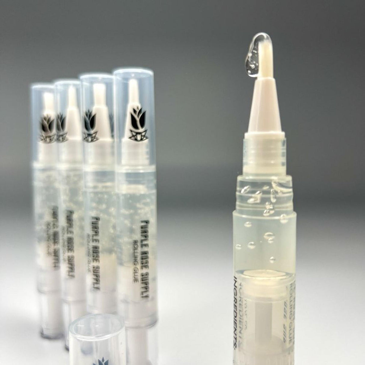 Rolling Glue Box - 4 ml - Carton of 24: Clear tubes with white caps, designed for spit-free, precise rolling adhesive application using a built-in brush.