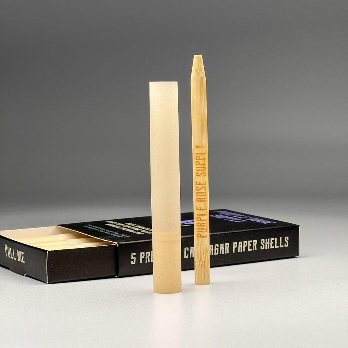 Small Shell Cones - Carton of 20: A box containing pre-formed paper shells designed for crafting premium cannagars, visible with a pencil for scale.