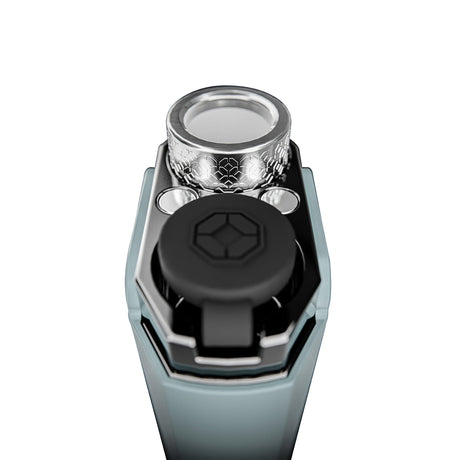 Hachi - Dark Gray close-up: flame-adjuster wheel, fuel level windows, ignition button, and teal-anodized body, showcasing its precision and portability.