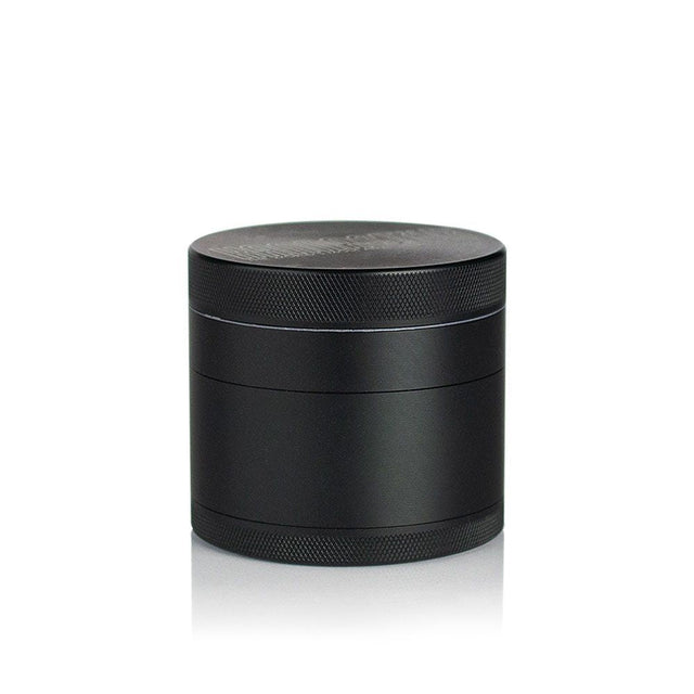 2.5 Multi Chamber Grinder - Black: A small, cylindrical, all-metal grinder with knurled bands for grip, featuring a four-piece modular design with a seam for separation.