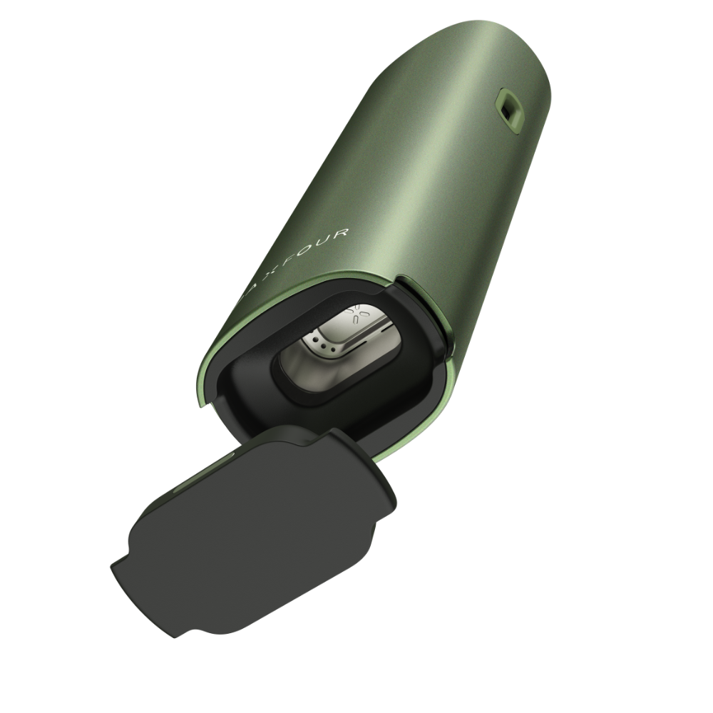PAX FOUR dry herb vaporizer in matte green, with the open hinged cap revealing the stainless-steel heating chamber and vapor-path insert. Compact, powerful, and easy to use.