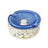 Symi Ashtray featuring a terrazzo-style concrete base with a swirled-blue glass insert, notched for cigarettes, highlighting its vintage-modern design.
