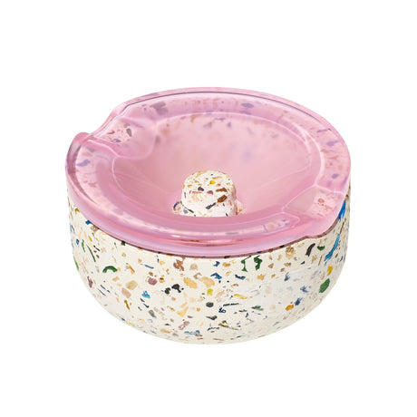 Symi Ashtray with terrazzo base and pink borosilicate glass lid, featuring grooves and knob, designed for modern functionality and vintage-inspired aesthetics.