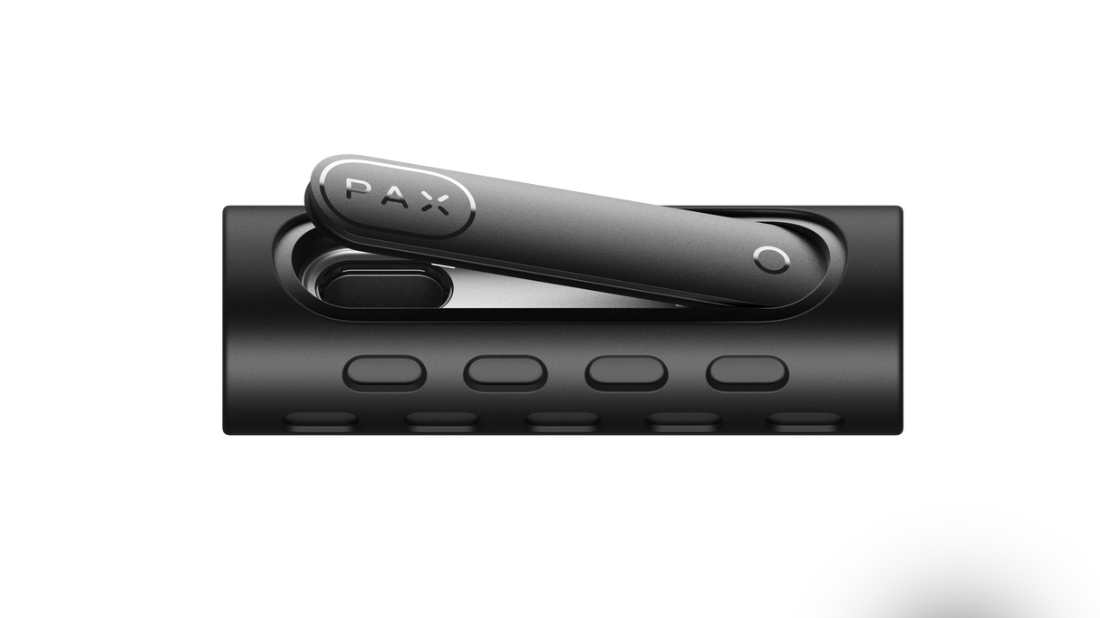 PAX FLOW black portable vaporizer in charging dock, showcasing its sleek design and compact form, highlighting advanced dry herb vaporization technology.