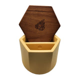 Malua Concrete Storage Jar with Walnut Lid, featuring a wooden coaster inside a yellow container, showcasing its stylish and functional design for cannabis storage.