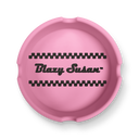 Classic Ashtray: A round silicone tray with black checker bands and Blazy Susan™ in bold script, designed for organizing small items.