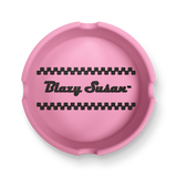 Classic Ashtray: A round silicone tray with black checker bands and Blazy Susan™ in bold script, designed for organizing small items.