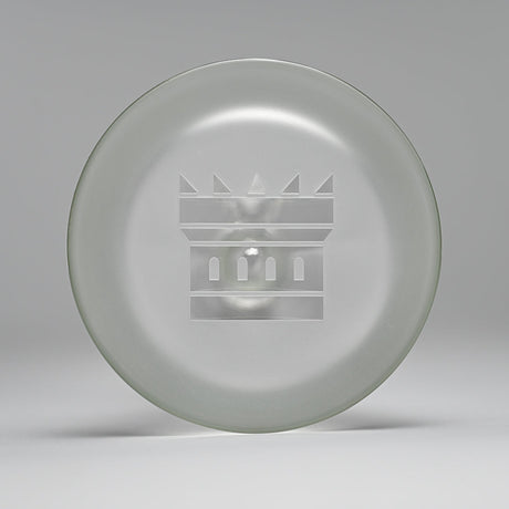 18 Glass Beaker Bong - Lines: A glass plate with a crown logo, showcasing intricate etched patterns, crafted for stability and elegance in high-quality borosilicate glass.