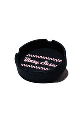 Classic Ashtray features a round design with three notches, showcasing a raised checker-stripe pattern and Blazy Susan branding on the bottom.