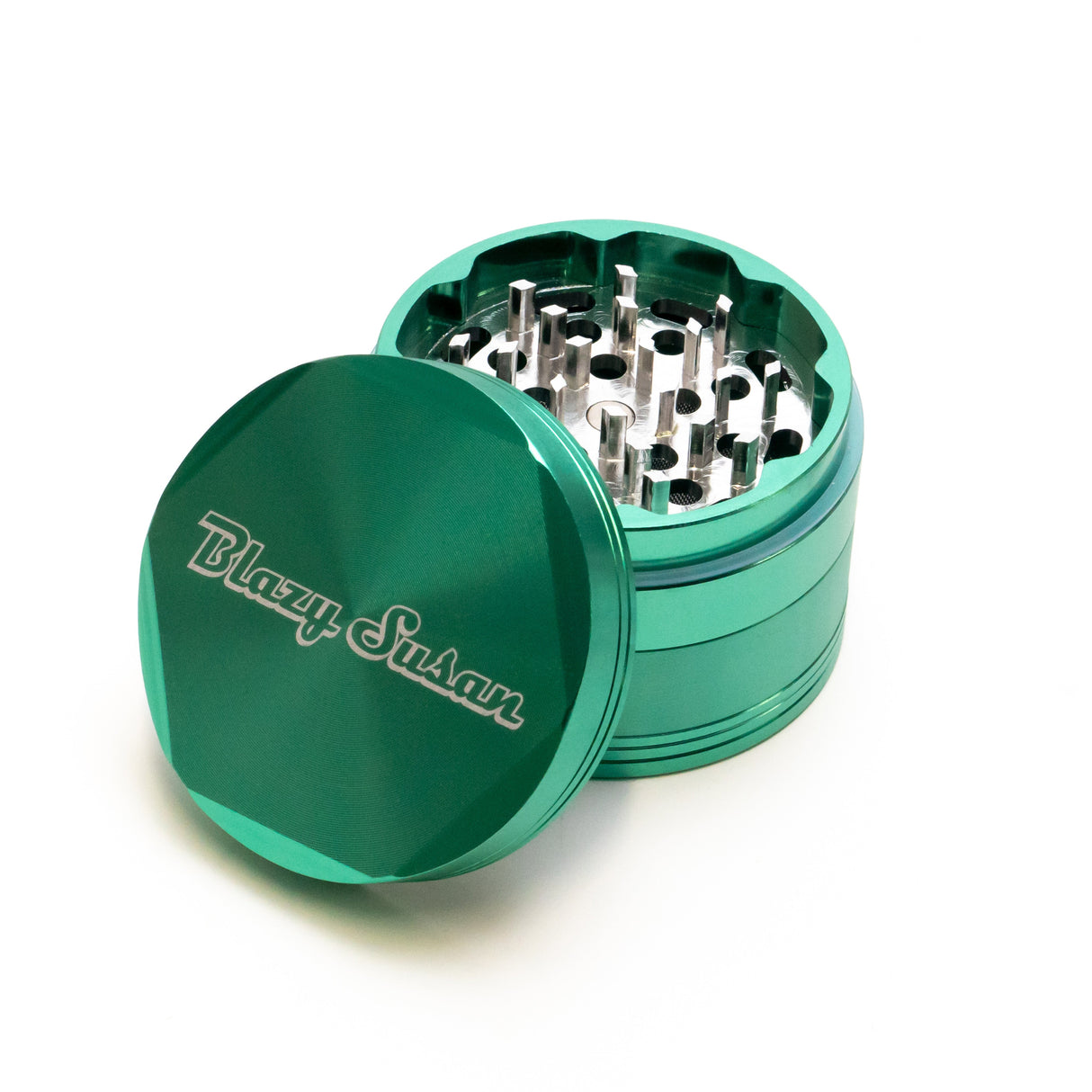 4-piece Aluminum Grinder 2.5 in bright green, showing removed lid with Blazy Susan logo and interlocking metal teeth for shredding herbs.