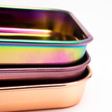 Stacked Blazy Susan Stainless Steel Rolling Trays in iridescent, bronze, and copper tones, showcasing a durable, compact design for organizing essentials.