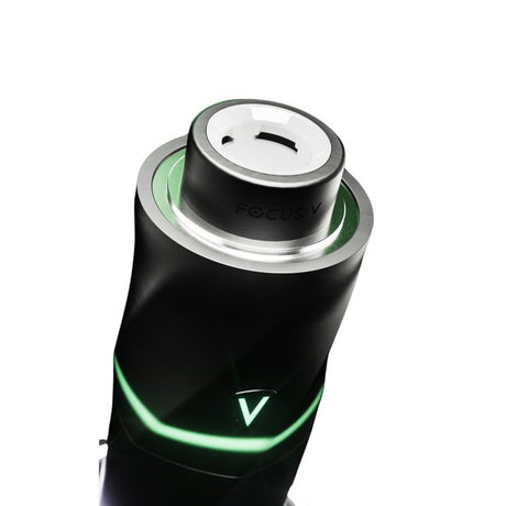 AERIS Portable E-Rig Kit's top view shows ceramic heating chamber, silver collar, and black body with glowing green V logo indicating power/temperature.