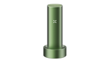 PAX FLOW vaporizer in olive-green sits in its matching charging dock, showcasing its X LED indicator, epitomizing advanced dry herb vaping technology.