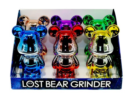 Countertop display box showcasing Grinder - Lost Bunny, featuring six metallic, cartoon-style bear herb grinders with chrome finishes, highlighting their compact, durable, and polished design.
