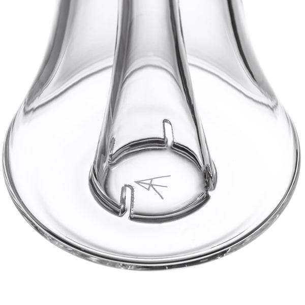 Close-up of the Lumina - Clear glass component, showcasing its circular base with notches and engraved logo, part of the MJ Arsenal Lumina Bubbler assembly.