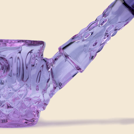 Close-up of the NWTN Home Highball Pipe, showcasing the translucent purple borosilicate glass with intricate diamond-cut details on the joint and body.