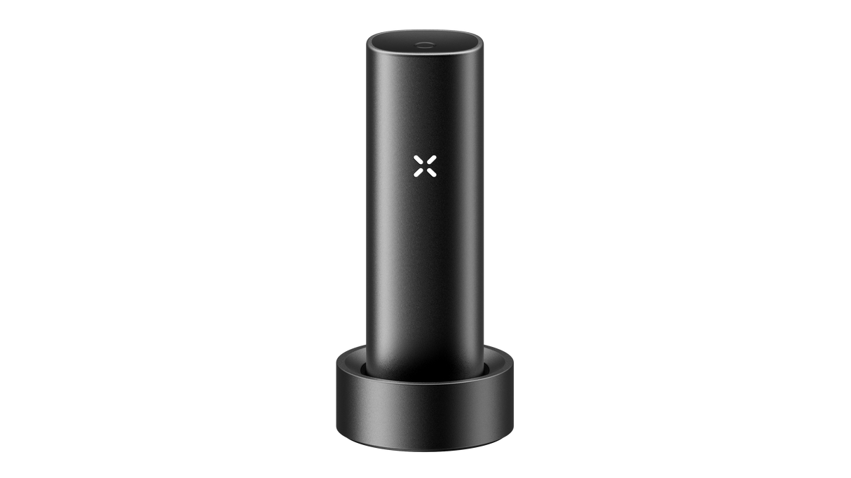 PAX FLOW vaporizer in charging cradle with visible PAX logo, showcasing its sleek, portable design and advanced technology for dry herb vaping.
