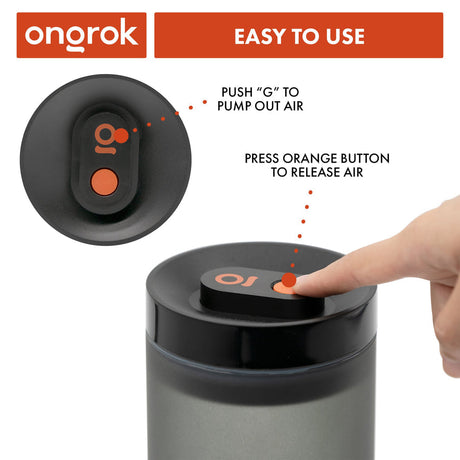 A finger activates the vacuum-sealed lid of the Airtight Vacuum Pump Storage Jar - Glass - 800ml, showcasing its UV-resistant, frosted design for preserving herbs.