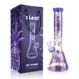 14 The Dreamer Beaker Bong with purple accents, featuring psychedelic skull-and-leaf artwork; includes matching box, bowl, and downstem.