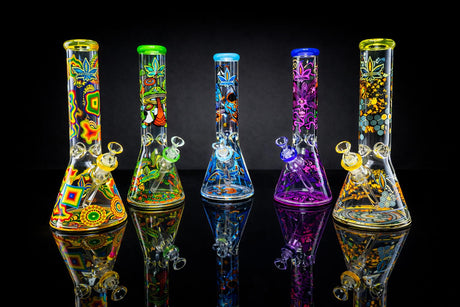 14 The Dreamer Beaker Bong with psychedelic designs, thick glass, and a stable base, displayed on a reflective surface. Includes bowl and downstem.