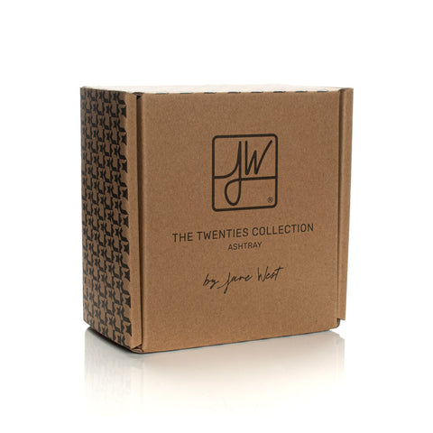 Square brown-kraft box with JW logo and text: THE TWENTIES COLLECTION – ASHTRAY by Jane West, packaging for the Twenties Collection Ashtray.