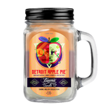 Scented Candle - Detroit Apple Pie in a glass jar with lid and apple design, featuring odor-eliminating enzymes and a 90-hour burn time.