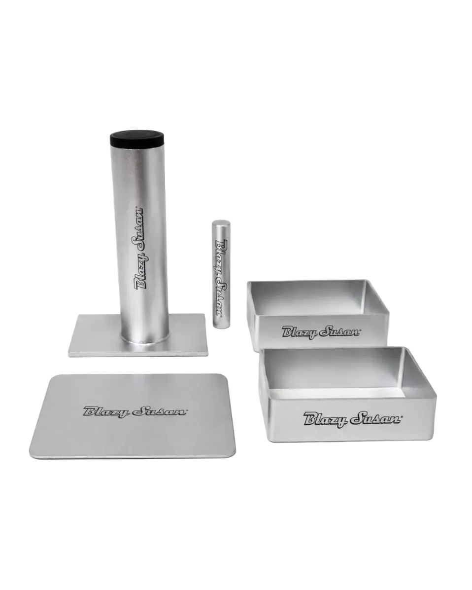 blazy susan silver rolling tray set featuring a tall cylindrical holder, smaller accessory tube, rectangular tray, and two compartment trays, each with the blazy susan logo