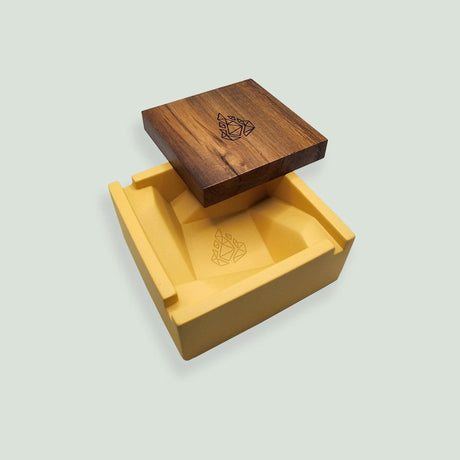 Briq Concrete Ashtray With Walnut Lid - Yellow, features a spiral design, solid concrete base, and a wooden lid with a logo on it.