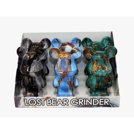 Countertop display of six Lost Bear Grinders, bear-shaped with marbled finish, showcasing sleek, chrome-coated design; perfect for dispensaries and head shops.