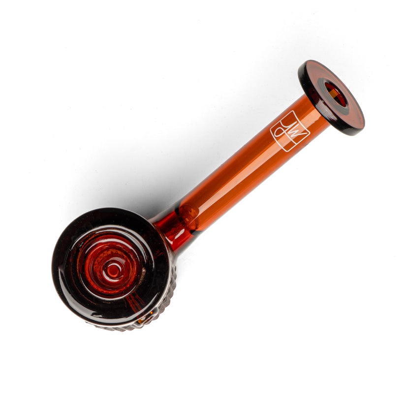 Twenties Collection Hand Pipe in amber borosilicate glass, featuring a textured grip, flat base, and ergonomic design for stability and ease of use.