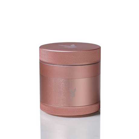 Close-up of the PLAYBOY x Kannastor 2.2 Grinder, showcasing its rose gold cylinder design, modular 4-piece build, and engineered drop-through system.